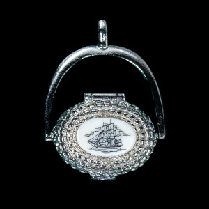 This is a beautifully detailed Sterling Silver Plated Nantucket Basket Pendant with a replica scrimshaw Tall Ship design.  More specifically the ship is that of a Whaling Bark. Inside the basket is a mini penny.  The basket on it's own has the following dimensions, .78"x .48"x .77".  The pendant holder add .22" x .85".  Each pendant weighs .31 ounces.  All the pendants come with an 18" Sterling Silver chain. The item number is SNB 4013.

This Nantucket Lightship basket pendant is made in pewter and was plated in Sterling Silver.  These beautiful baskets are similar to what is seen on the Netflix hit, Sirens

Nantucket lightship baskets, characterized by their rattan staves, cane weavers, and wooden bases, originated on the island's lightships in the mid-1800s. Initially, these baskets were a way for lightship crewmen to pass the time during long deployments and were primarily utilitarian. Over time, the baskets evolved, becoming more refined and sought after as souvenirs of Nantucket.

Keeping with the tradition of a penny in the basket.  A penny is placed inside the basket to symbolize good luck.  Each of our basket pendants have a mini penny inside to carry on the tradition.  

Linda Layden has been making beautiful works of art in the scrimshaw field for over 40 years.  Originally a hobby that became a full time job.  Her work can be found in gift shops, galleries and museums across the world.  

The resin scrimshaw piece is originally hand etched by Linda Layden.  We make a mold of the original piece and do an open cast pour of our resin mixture.  The pieces are removed from the mold and sanded and inked with Indian Ink.

We believe that serving nature is one of the commissions that we as humans have been given here on earth.  We wish to lend our resources to those charged with protecting elephants from poaching.  On a monthly basis we donate to organizations whose purpose to protect the elephants and other species throughout the planet.  We focus our donations on organizations that put the money to good use and have a low overhead. With the majority of incoming funds going back to saving the elephants!

American Made
Nantucket Basket Pendant
Sterling Silver Plated
Pewter Base 
Mini Penny 
18" Sterling Silver Chain
Nautical Design Top

Etched Tall Ship
Whale Bark
Resin Scrimshaw
Lifetime Guarantee