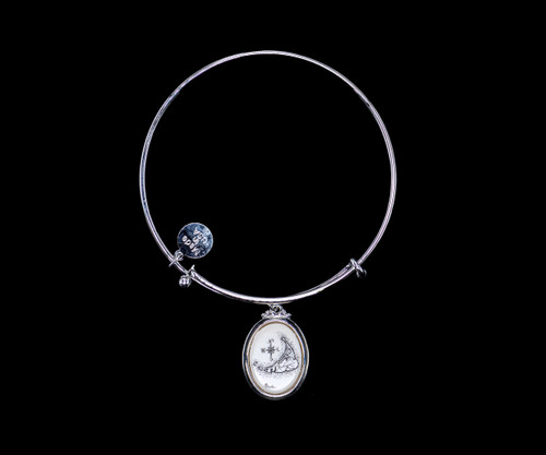 NC 07 438 Nantucket Map Adjustable Bracelet Display.  The beautiful adjustable bracelet is decorated with Scrimshaw Nantucket Island design.  The product ID is NC 07-438-SEV.  The design of the Lighthouse, is that of Great Point Lighthouse which is located in Nantucket, MA.  

This bracelet is a one size for most, with an adjustable wire band.  Each bracelet can be customized with different unique charms to attach.  All parts are made in the USA!.

The Eco-Ivory Scrimshaw Charm is 13x18.  The artwork was originally hand etched by Linda Layden.

Linda Layden has been making beautiful works of art in the scrimshaw field for over 40 years.  Originally a hobby that became a full time job.  Her work can be found in gift shops, galleries and museums across the world.  

We make a mold of the original piece and do an open cast pour of our resin mixture.  The pieces are removed from the mold and sanded and inked.