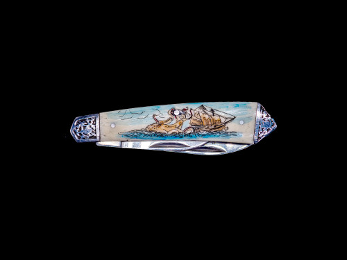 This unique hand etched Octopus and Ship Colored design on a 440 Stainless Steel Dual Blade Knife.  The knife design is similar to the Shrade 33 knife.  The stunning design has a giant Octopus attacking a tall ship at sea. This beautiful knife is part of the Scrimshaw Collection, with those words laser engraved into the blade.  The DB 33 knifes come with the pictured leather sheath and each scale is made with Bovine Bone.  The DB 33 Knife has bolsters that are nickel silver with brass pins and liner.  It is a dual blade knife and a very useful pocket knife.  The dimensions of the DB 33 Pocket Knife with the blade closed are 3.28" x 0.69" x 0.50".  The large blade itself is approximately 2.45" making the width of the knife with an open blades 5.73".  The small blades length is approximately 1.77".  The SKU is DB 33 - 403.