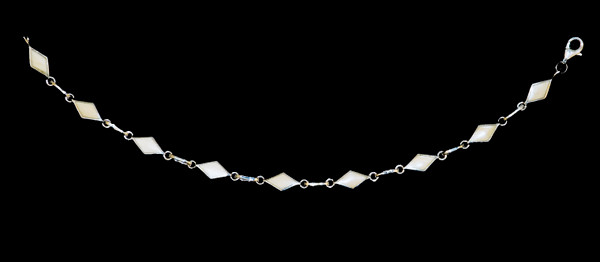 This trendy round mammoth ivory is inlayed into an elegant diamond shaped sterling silver bracelet.  The dimension of the bracelet is approximately 6.72" x .25".