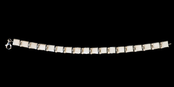 This trendy mammoth ivory is inlayed into an elegant square shaped shaped sterling silver bracelet.  The dimension of the bracelet is approximately 7" x .186".