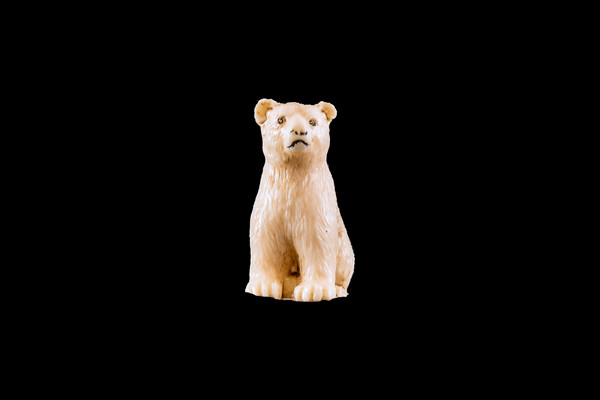 This is a beautiful hand carved eco-ivory Bear Sitting Statue.  The dimensions of the Bear Sitting Statue are .64" x 1.38" x .91".  The SKU is C-15.

This unique Bear Sitting statue will make a great addition to any room in the house.  You can place it on any flat surface to diplay, or a great gift for children to have.

All statues are hand carved in clay.  We then make a mold of the original piece before producing them into the final acrylic resin product.