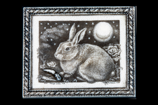 This is a wonderful wall plaque was originally hand etched Midnight Snack Wall Plaque design.  The desin has a bunny eating a carrot snack under the moonlight.  This unique piece also has 3 dimensional hand carvings.  This is part of the incredible line of Mossup Valley Designs that we carry, with the wonderful artist Rachel Badeau.  The dimensions of the plaque are 5.58" x 4.59" x 0.41".  The SKU is MVD WP 16.

Rachel Badeau has been etching and engraving in a variety of media for over thirty years.  Her work, characterized by fine line and intricate detail, attempts to touch the hearts and emotions of others.  All while reflecting her love of animals, nature and the human spirit.