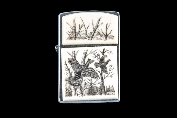 This is a beautifully originally hand etched Eco-Ivory Ruffed Grouse designed Zippo Lighter! The top of the flip lighter has a a Birch Tree's design.  The Zippo is a Brushed Chrome finish. Each lighter has a bottom stamp signifying the year it was made, is refillable. All windproof lighters are American made in Bradford, PA factory and come packaged in a gift box.  This is part of the Save the Elephant Collection and was originally hand etched by Linda Layden. The SKU is NC 54 - 120

The Zippo Lighter is 2.24" x 1.51" x 0.59".  It weighs 2.04 oz.