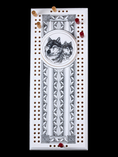 This wonderful two person and our two team cribbage boards is a beautiful accent piece for your home or take it on the road for use as a travel cribbage board.  With the magnet holding the center piece and pegs in place it is a stunning travel cribbage board. 

This is a unique originally hand etched Dual Wolf Face Eco - Ivory Scrimshaw Cribbage Board!   The center circular piece has a magnet holding it in place.  Pushing on the base of the piece pops the Large round off the board, where the pegs are stored.  All cribbage boards come with 3 red and 3 white/yellow wooden pegs. 

The cribbage board itself is made for two players or teams.  The board has a native geometric design that was originally hand etched.  The large round piece has a magned on the back to keep it secured to the board and store the pegs.  The pegs are made of wood.  This is part of the Save the Elephant Collection and was originally hand etched by Linda Layden.  The SKU is NC 53 - 103.

The Cribbage Board is 8.50" x 3.46" x 0.46".  It weighs 11.28 oz.