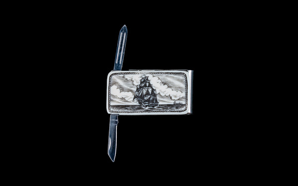 NC 20 401 Tall Ship Money Clip Knife with blade open.  This beautiful originally hand etched Tall Ship design on a Large Rectangle Knife Money Clip.  This unique money clip has a small knife blade and a nail filer.  This is a useful money clip that duals as a practical knife.

The artwork was originally hand etched by Linda Layden.  The dimensions of the Large Rectangle Knife Money Clip with the blade(s) closed are 2.08" x 1.32" x 0.30".  The knife blade itself is approximately 1.45" and the nail file is approximately 1.50", making the width of the money clip with both open 5.03".  The SKU is NC 20 - 401.

Linda Layden has been making beautiful works of art in the scrimshaw field for over 40 years.  Originally a hobby that became a full time job.  Her work can be found in gift shops, galleries and museums across the world.  

The resin scrimshaw piece is originally hand etched by Linda Layden.  We make a mold of the original piece and do an open cast pour of our resin mixture.  The pieces are removed from the mold and sanded and inked.