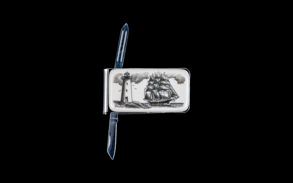 NC 20 Ship and Lighthouse Knife Open.  This beautiful originally hand etched Ship and Lighthouse design on a Large Rectangle Knife Money Clip.  This unique money clip has a small knife blade and a nail filer.  This is a useful money clip that duals as a practical knife.

The artwork was originally hand etched by Linda Layden.  The dimensions of the Large Rectangle Knife Money Clip with the blade(s) closed are 2.08" x 1.32" x 0.30".  The knife blade itself is approximately 1.45" and the nail file is approximately 1.50", making the width of the money clip with both open 5.03".  The SKU is NC 20 - 406.

Linda Layden has been making beautiful works of art in the scrimshaw field for over 40 years.  Originally a hobby that became a full time job.  Her work can be found in gift shops, galleries and museums across the world.  

The resin scrimshaw piece is originally hand etched by Linda Layden.  We make a mold of the original piece and do an open cast pour of our resin mixture.  The pieces are removed from the mold and sanded and inked.

We believe that serving nature is one of the commissions that we as humans have been given here on earth.  We wish to lend our resources to those charged with protecting elephants from poaching for their ivory. 

On a monthly basis we donate to organizations whose purpose to protect the elephants and other species throughout the planet.  We focus our donations on organizations that put the money to good use and have a low overhead. With the majority of incoming funds going back to saving the elephants!

Features
Hand Etched Acrylic Resin Scrimshaw 
Originally Hand Etched in the USA! 
NC 20 Large Rectangle Money Clip Knife
Stainless Steel 
Small Knife Blade
Small Nail Filer
Nautical Design
Ship and Lighthouse
Save the Elephant Collection