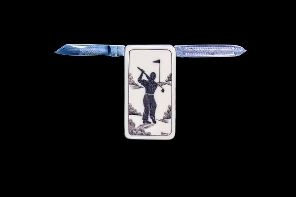 NC 20K 152 Golfer Open.  This beautiful originally hand etched Golfer design on a Large Rectangle Knife Money Clip.  This unique money clip has a small knife blade and a nail filer.  This is a practical money clip that duals as a practical knife.

The artwork was originally hand etched by Linda Layden.  The dimensions of the Large Rectangle Knife Money Clip with the blade(s) closed are 2.08" x 1.32" x 0.30".  The knife blade itself is approximately 1.45" and the nail file is approximately 1.50", making the width of the money clip with both open 5.03".  The SKU is NC 20K - 152.

Linda Layden has been making beautiful works of art in the scrimshaw field for over 40 years.  Originally a hobby that became a full time job.  Her work can be found in gift shops, galleries and museums across the world.