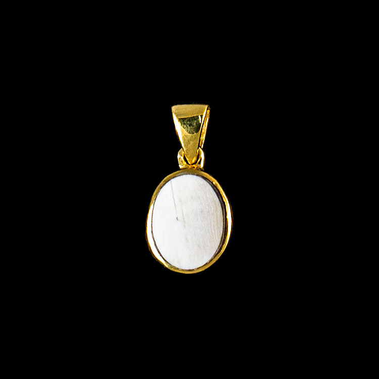 This trendy round shaped mammoth ivory is inlayed into a round 14K Gold pendant.  This pendant comes with an 18" 14K Gold chain.  The dimensions of the mammoth pendant tusk is approximately .5" x .36".