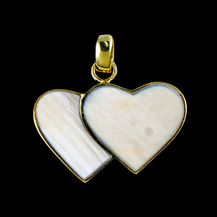 This beautiful large double heart shaped mammoth ivory tusk is inlayed into a 14K Gold pendant.  This pendant comes with an 18" 14K Gold chain.  The dimensions of the mammoth pendant tusk is approximately .92" x 1.61".