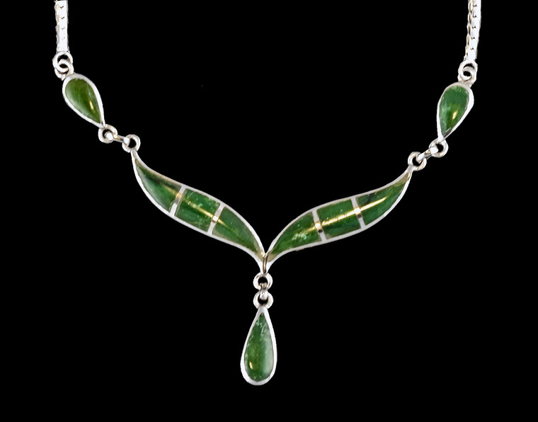 This unique whale tail with Teardrop Alaskan Jade shaped whale tail is inlayed into a sterling silver pendant.  This pendant comes with an 18" Sterling Silver chain.  The dimensions of the Alaskan Jade pendant is approximately 2.25" x 1.7".