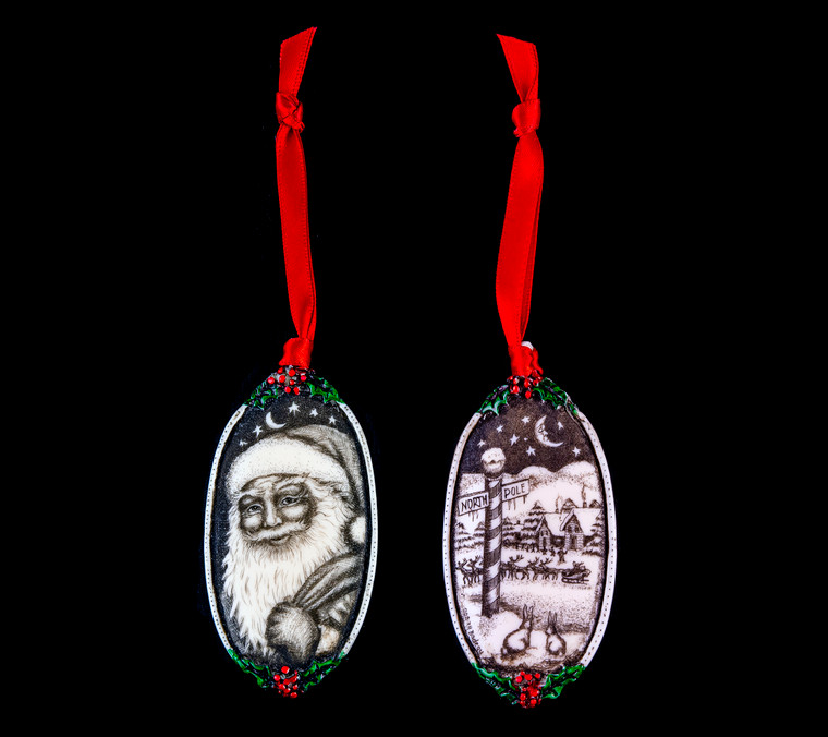 This is a beautiful double sided ornament with a Santa theme.  This is part of the incredible line of Mossup Valley Designs that we carry, with the wonderful artist Rachel Badeau.  The dimensions of the ornament are 3.28" x 1.61".  The SKU is MVD ORN 9.

On this double sided ornament, Christmas designs are prominently featured on both sides.  On one side there is closeup of Santa's face while holding a bag of toys design.  On the other side of the ornament, a North Pole Design.

Rachel Badeau has been etching and engraving in a variety of media for over thirty years.  Her work, characterized by fine line and intricate detail, attempts to touch the hearts and emotions of others.  All while reflecting her love of animals, nature and the human spirit.