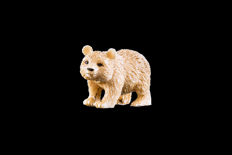 This is a beautiful hand carved eco-ivory Walking Bear Statue.  The dimensions of the Walking Bear Statue are .77" x 1.10" x 2.04".  The SKU is C-16.

This unique Bear Sitting statue will make a great addition to any room in the house.  You can place it on any flat surface to diplay, or a great gift for children to have.

All statues are hand carved in clay.  We then make a mold of the original piece before producing them into the final acrylic resin product.