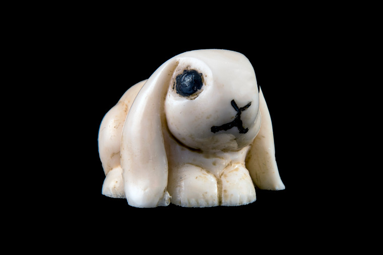 This is a detailed hand carved eco-ivory Small Bunny Statue  The dimensions of the Small Bunny Statue are 1.04" x 0.87" x 1.29".  The SKU is C-31.  

This stunning Small Bunny Statue will make a great addition to any room in the house.  You can place it on any flat surface to display, or a great gift for children to have.

All statues are hand carved in clay.  We then make a mold of the original piece before producing them into the final acrylic resin product with an antique finish.