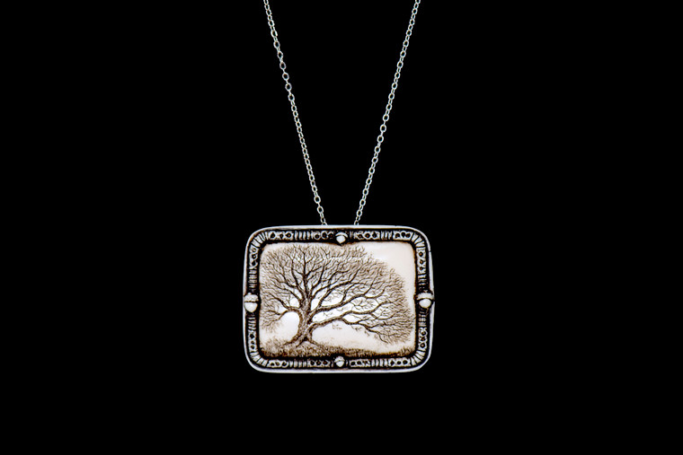 MVD PN 11 Woodland Chain.  With our unique backing, you can wear this stunning piece either as a pin or pendant with the included 18" Silver Plated Chain.  This distinct originally hand etched Woodland designed pin/pendant.  The Woodland design features an Oak Tree.  The backing of this piece has the findings to be a pin, as well as a pendant.  They come with an 18" Silver Plated Chain.  This is part of the incredible line of Mossup Valley Designs that we carry, with the wonderful artist Rachel Badeau.  The dimensions of the necklace are 1.82" x 1.41" x 0.43".  The SKU is MVD PN 11.

Rachel Badeau has been etching and engraving in a variety of media for over thirty years.  Her work, characterized by fine line and intricate detail, attempts to touch the hearts and emotions of others.  All while reflecting her love of animals, nature and the human spirit.