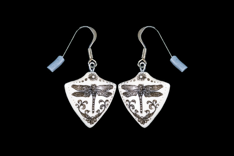 This is a unique originally hand etched Dragonfly French Wire Earring set. This is part of the incredible line of Mossup Valley Designs that we carry, with the wonderful artist Rachel Badeau.  All the earrings come carded.  The dimensions of the earrings are 0.76" x 0.81" x 0.17".  The SKU is MVD ER 02.

Rachel Badeau has been etching and engraving in a variety of media for over thirty years.  Her work, characterized by fine line and intricate detail, attempts to touch the hearts and emotions of others.  All while reflecting her love of animals, nature and the human spirit.  

The resin scrimshaw piece is originally hand etched by Rachel Badeau.  We make a mold of the original piece and do an open cast pour of our resin mixture.  The pieces are removed from the mold and sanded and inked.