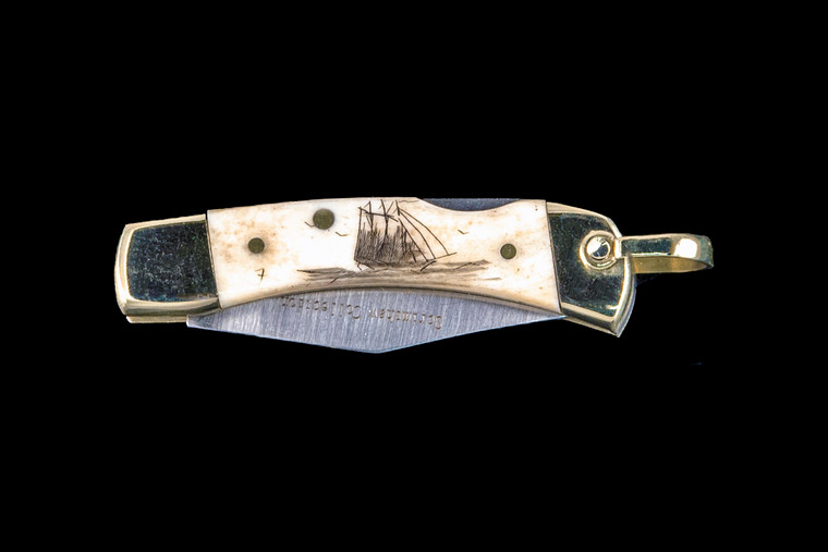 This unique hand etched Tall Ship design on a 440 Stainless Steel Blade LB 1 Knife.  This beautiful knife is part of the Scrimshaw Collection, with those words laser engraved into the blade.  The LB 1 knifes come with the pictured leather sheath and each scale is made with Bovine Bone.  The LB 1 Knife has bolsters and shackle that are nickel silver with brass pins and liner.  It is a lock blade knife and a very useful pocket knife. The knife also has a key chain ring at the end of the knife.  The dimensions of the LB 1 Pocket Knife with the blade closed are 2.24" x 0.68" x 0.31".  The blade itself is approximately 1.67" making the width of the knife with an open blade 3.91".  The SKU is LB-1 401.

The scrimshaw is inked with black india ink and sealed with renaissance wax, which is used by museums for antique restoration.  It also helps bring out the beauty of the artwork as well as in the cow bone. The knife is water resistant, but not waterproof.