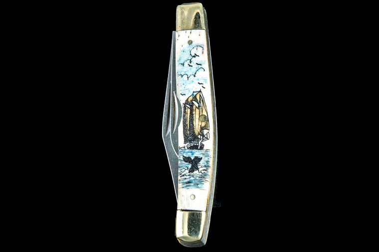 This unique hand etched Ship and Whale vertical design on a 440 Stainless Steel Dual Blade Knife.  The knife design is similar to the Shrade 33 knife.  This beautiful knife is part of the Scrimshaw Collection, with those words laser engraved into the blade.  The DB 33 knifes come with the pictured leather sheath and each scale is made with Bovine Bone.  The DB 33 Knife has bolsters and shackle that are nickel silver with brass pins and liner.  It is a dual blade knife and a very useful pocket knife.  The dimensions of the DB 33 Pocket Knife with the blade closed are 3.28" x 0.69" x 0.50".  The large blade itself is approximately 2.45" making the width of the knife with an open blades 5.73".  The small blades length is approximately 1.77".  The SKU is DB 33 - 403.

The scrimshaw is inked with colored india ink and sealed with renaissance wax, which is used by museums for antique restoration.  It also helps bring out the beauty of the artwork as well as in the cow bone. The knife is water resistant, but not waterproof.