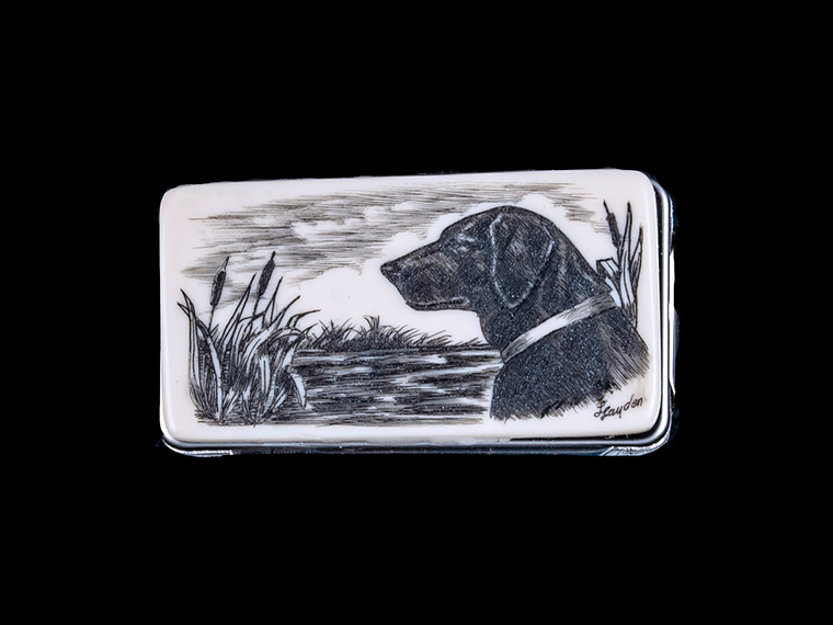 This stunning originally hand etched Black Lab design on a Large Slide Rectangle Money Clip.  This unique piece is a slide money clip.

The artwork was originally hand etched by Linda Layden.  The dimensions of the Large Rectangle Money Clip is 2.08" x 1.32" x 0.30".  The SKU is NC 22 - 135.

Linda Layden has been making beautiful works of art in the scrimshaw field for over 40 years.  Originally a hobby that became a full time job.  Her work can be found in gift shops, galleries and museums across the world.  

The resin scrimshaw piece is originally hand etched by Linda Layden.  We make a mold of the original piece and do an open cast pour of our resin mixture.  The pieces are removed from the mold and sanded and inked.

We believe that serving nature is one of the commissions that we as humans have been given here on earth.  We wish to lend our resources to those charged with protecting elephants from poaching for their ivory. 

On a monthly basis we donate to organizations whose purpose to protect the elephants and other species throughout the planet.  We focus our donations on organizations that put the money to good use and have a low overhead. With the majority of incoming funds going back to saving the elephants!

Features
Hand Etched Acrylic Resin Scrimshaw 
Originally Hand Etched in the USA! 
NC 22 Large Rectangle Money Clip Knife
Stainless Steel 
Animal Design
Black Lab
Save the Elephant Collection