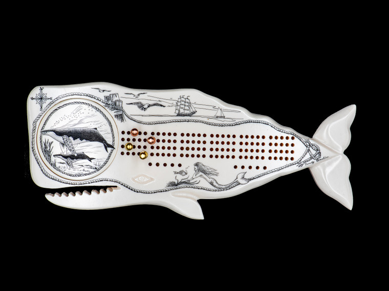 Double Humpback Whale Shaped Cribbage Board.This wonderful two person and our two team cribbage boards is a beautiful accent piece for your home or take it on the road for use as a travel cribbage board.  With the magnet holding the center piece and pegs in place it is a stunning travel cribbage board that will keep the pegs in place. 

This is a beautiful originally hand etched Double Humpback Whale Eco - Ivory Scrimshaw Whale Shaped Cribbage Board!  The board itself is shaped of a Humpback Whale.  The center circular piece has a magnet holding it in place.  Pushing on the base of the piece pops the Large round off the board, where the pegs are stored.  All cribbage boards come with 3 Silver and 3 Gold Metal pegs. 

The cribbage board itself is made for two players or teams.  The board has a native geometric design that was originally hand etched.  The large round piece has a magnet on the back to keep it secured to the board and store the pegs.  The pegs are made of wood.  This is part of the Save the Elephant Collection and was originally hand etched by Linda Layden.  The SKU is NC 53 - 406.

The Cribbage Board is 9.00" x 3.54" x 0.48".  It weighs 7.35 oz.