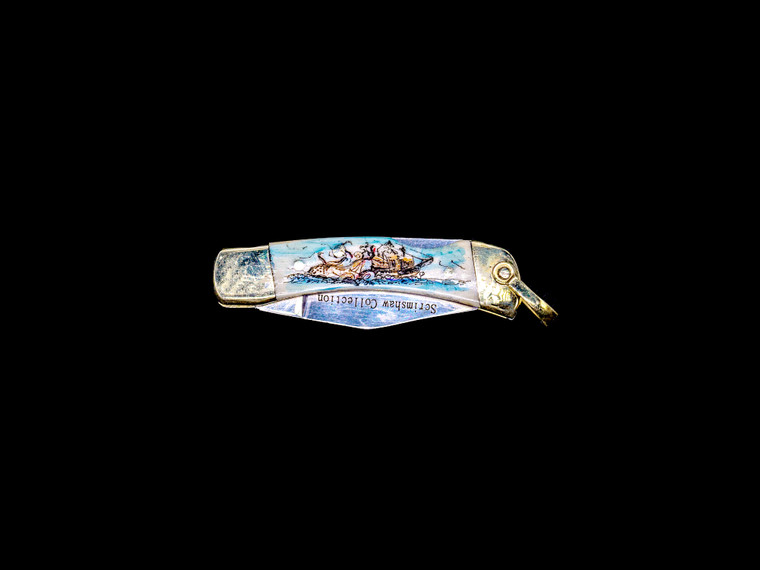 This unique hand etched Octopus and Ship Colored design on a 440 Stainless Steel Blade LB 1 Knife. The stunning design has a giant Octopus attacking a tall ship at sea. This beautiful knife is part of the Scrimshaw Collection, with those words laser engraved into the blade.  The LB 1 knifes come with the pictured leather sheath and each scale is made with Bovine Bone.  The LB 1 Knife has bolsters and shackle that are nickel silver with brass pins and liner.  It is a lock blade knife and a very useful pocket knife. The knife also has a key chain ring at the end of the knife.  The dimensions of the LB 1 Pocket Knife with the blade closed are 2.24" x 0.68" x 0.31".  The blade itself is approximately 1.67" making the width of the knife with an open blade 3.91".  The SKU is LB-1 409.