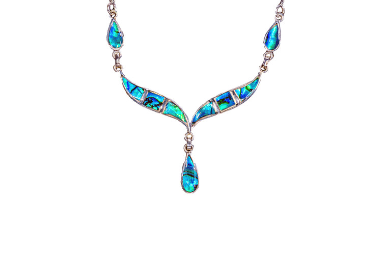 This beautiful Whale Tail with Teardrop Paua Shell is inlayed into a Sterling Silver Pendant. This stunning pendant comes with an 18" Sterling Silver chain.  The dimensions of the Paua Shell pendant is approximately 2.25" x 1.7".  The product id # is PNL-1008-S

This is our line of PĀUA Shell Jewelry.  In New Zealand, abalone is called pāua or blackfoot pāua is the ubiquitous New Zealand pāua the highly polished nacre of which is extremely popular as souvenirs with its striking blue, green, and purple iridescence that allows for the stunning jewelry.

Enjoy your unique pendant!!

Features:
Northern Lights
     Paua Shell
Whale Tail Shaped 
Sterling Silver
Lifetime Guarantee!!
