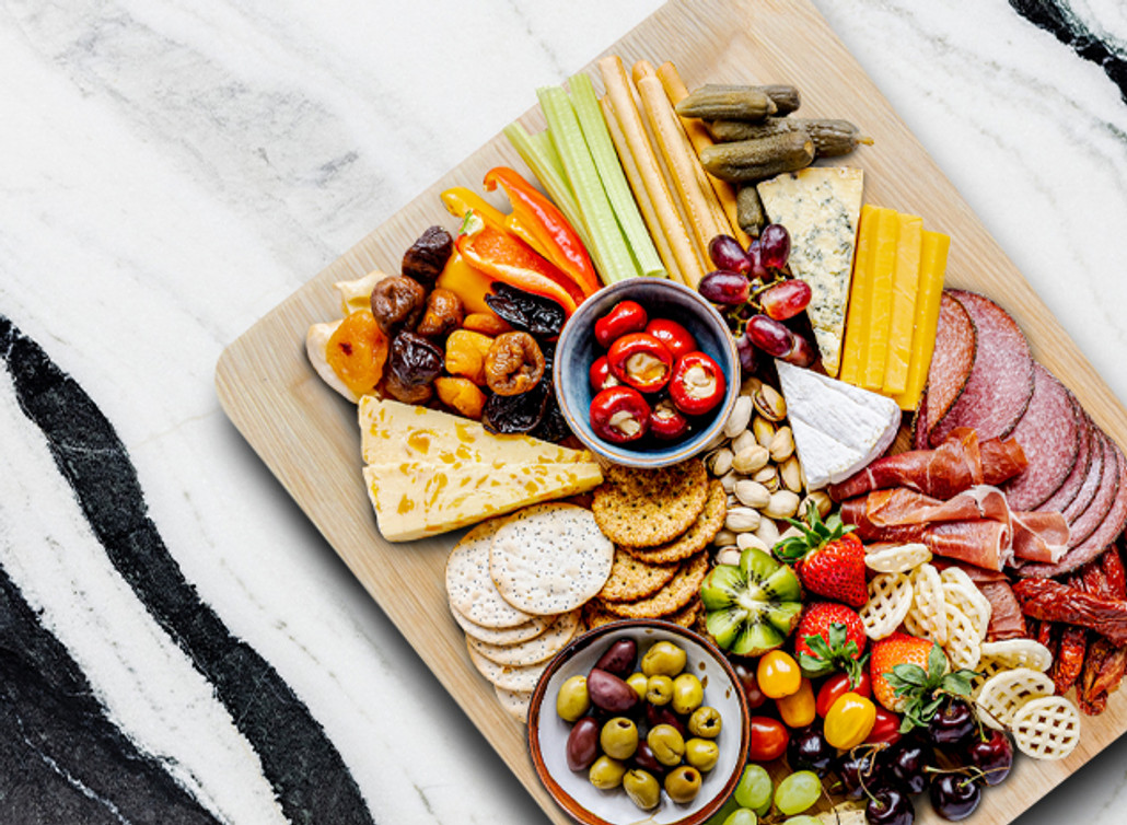 ​Using a palm leaf plate as a charcuterie board is a great idea for a potluck party! 