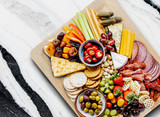 ​Using a palm leaf plate as a charcuterie board is a great idea for a potluck party! 