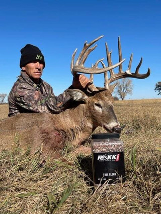 man posing with a buck and rakk fuel product