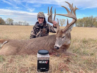 man posing with a buck and rakk fuel product