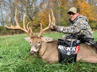 man posing with a buck and rakk fuel product