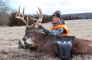 woman posing with a buck and rakk fuel product