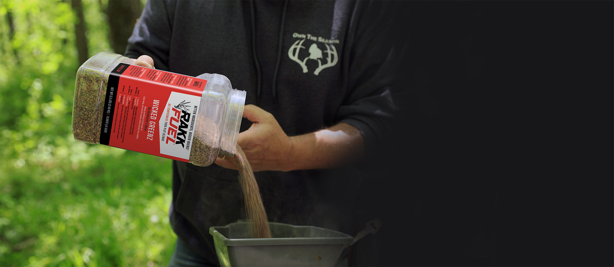 Man pouring food plot seed into seed planter