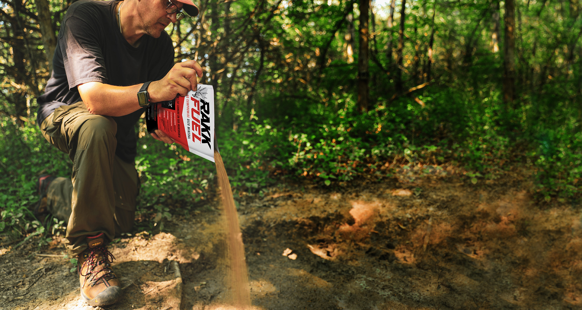 Man pouring deer mineral onto the ground