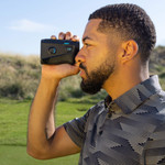 Male golfer looking through Tour V6 Shift Laser Rangefinder Black Variant Male golfer looking through Tour V6 Shift Laser Rangefinder Black Variant