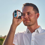 Male golfer looking through Tour V6 Shift Laser Rangefinder White Variant Male golfer looking through Tour V6 Shift Laser Rangefinder White Variant