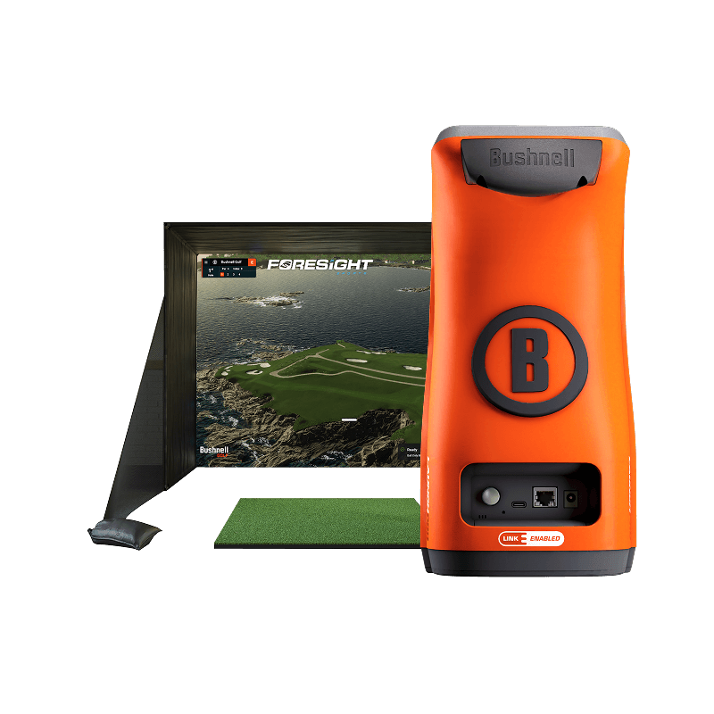 Bushnell Launch Pro Simulator Package showing a golfer hitting into a full enclosure, screen, and mat setup with the launch monitor.