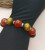 Bracelet of tiger eye beads of 16mm and red agate of 16mm beads, with golden and silver zirconia spacer. Preferably for ladies