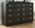 Hyndell - Dark Brown - 5 Pc. - Dresser, Mirror, Chest, Queen Upholstered Panel Bed With Bench Footboard