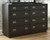 Hyndell - Dark Brown - 5 Pc. - Dresser, Mirror, Chest, California King Upholstered Panel Bed With Bench Footboard