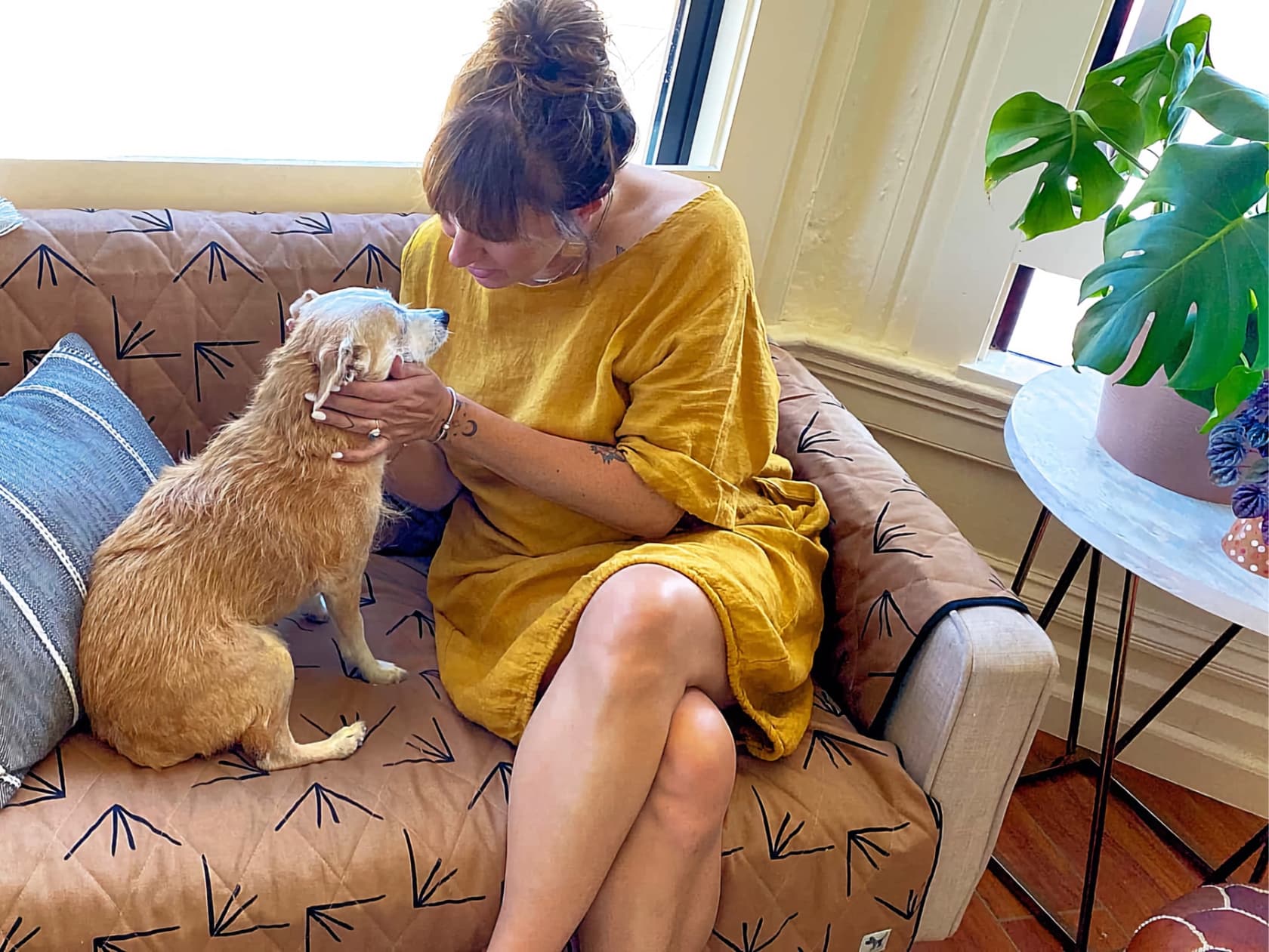 woman on a couch with her dog