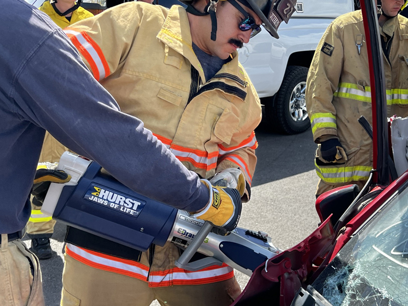 Photo of a Hurst eDRUALIC rescue tool cutting in to a vehicle.