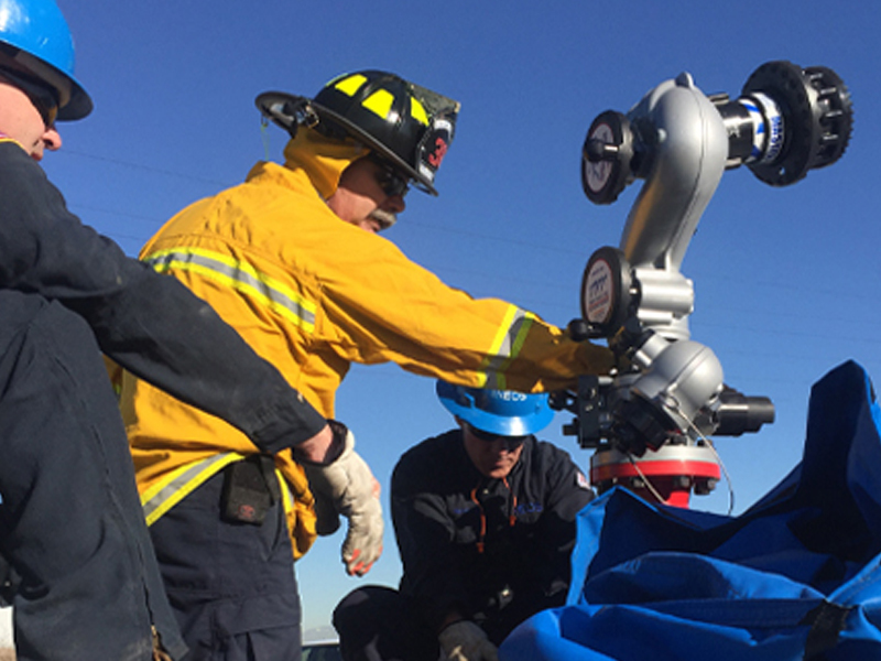 Photo of Curtis Industrial specialist working with a TFT water flow monitor.
