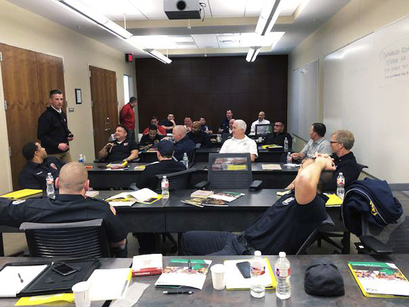 Photo of firefighters in a classroom learning about PPE