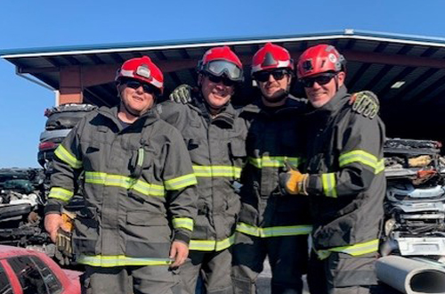 Curtis Heavy Rescue team at a vehicle extrication demonstration in turnouts, helmets and googles.