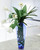 Waterlook® White Tulips Wrapped in Woven Blades in Tall Blue Vase