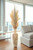 Plumes Mixed with Dried Grasses in Tall Wooden Vase