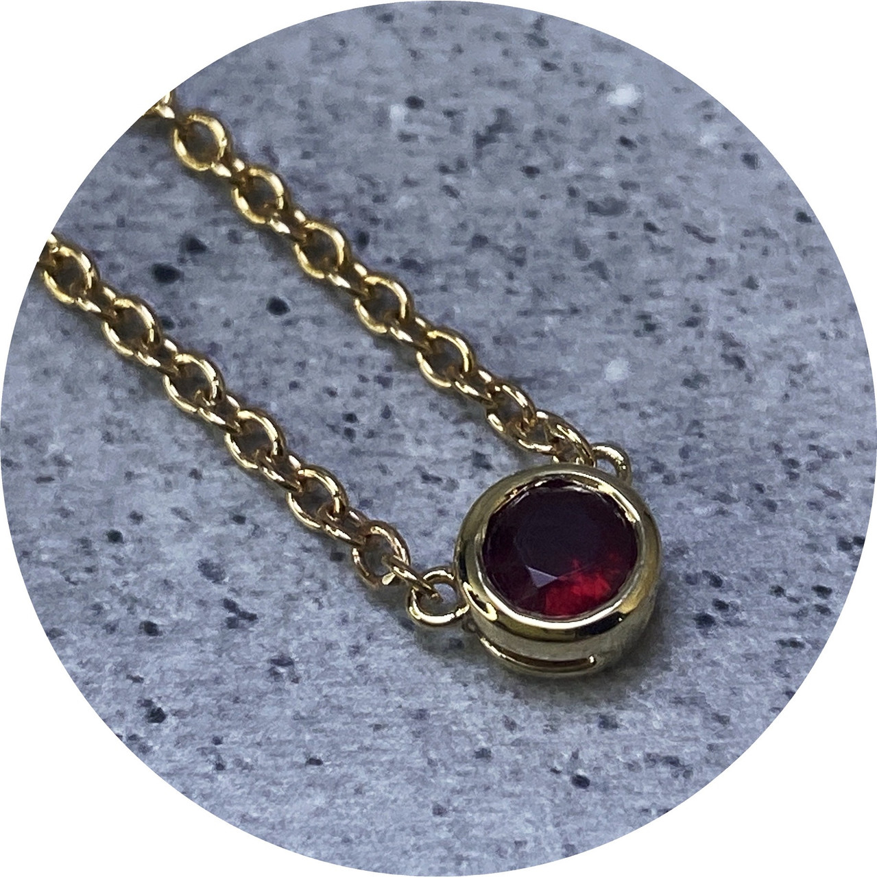 KIN- 9ct yellow gold and ruby bezel set KIN