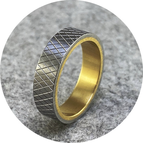 Phoebe Porter- Diamond cut sleeved ring. Stainless steel and 18ct yellow gold inner. size M. Phoebe Porter- Diamond cut sleeved ring. Stainless steel and 18ct yellow gold inner. size M.