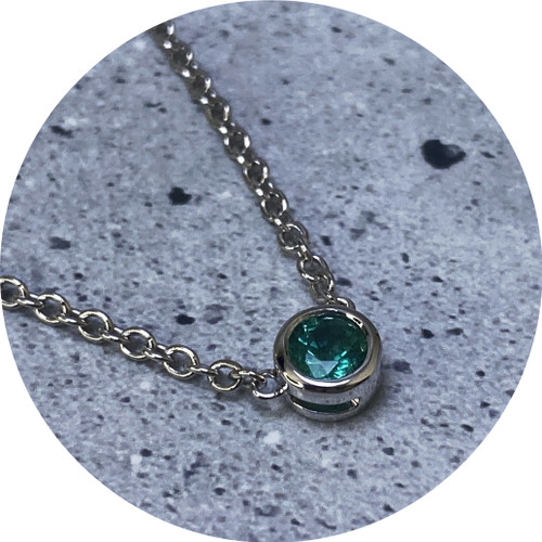 KIN- 9ct white gold, emerald pendant and necklace. 0.25ct.